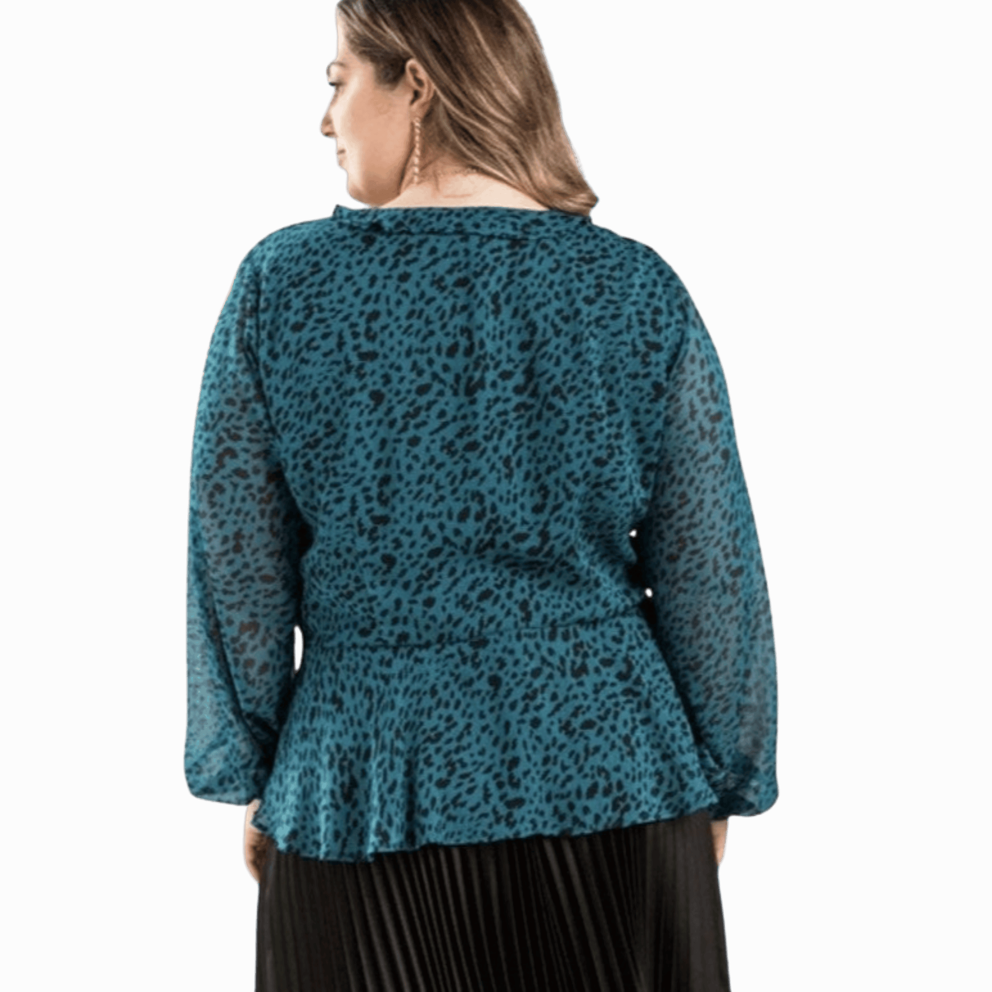 Woman wearing a teal leopard print top on a gray background