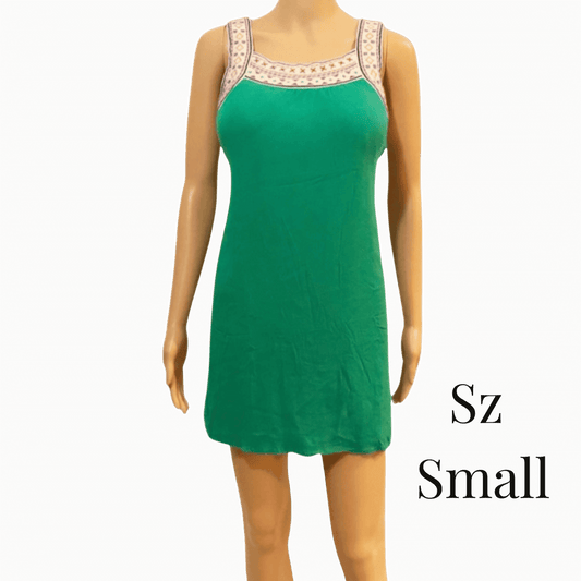 Green dress on a mannequin with 'Sz Small' text against a brown background