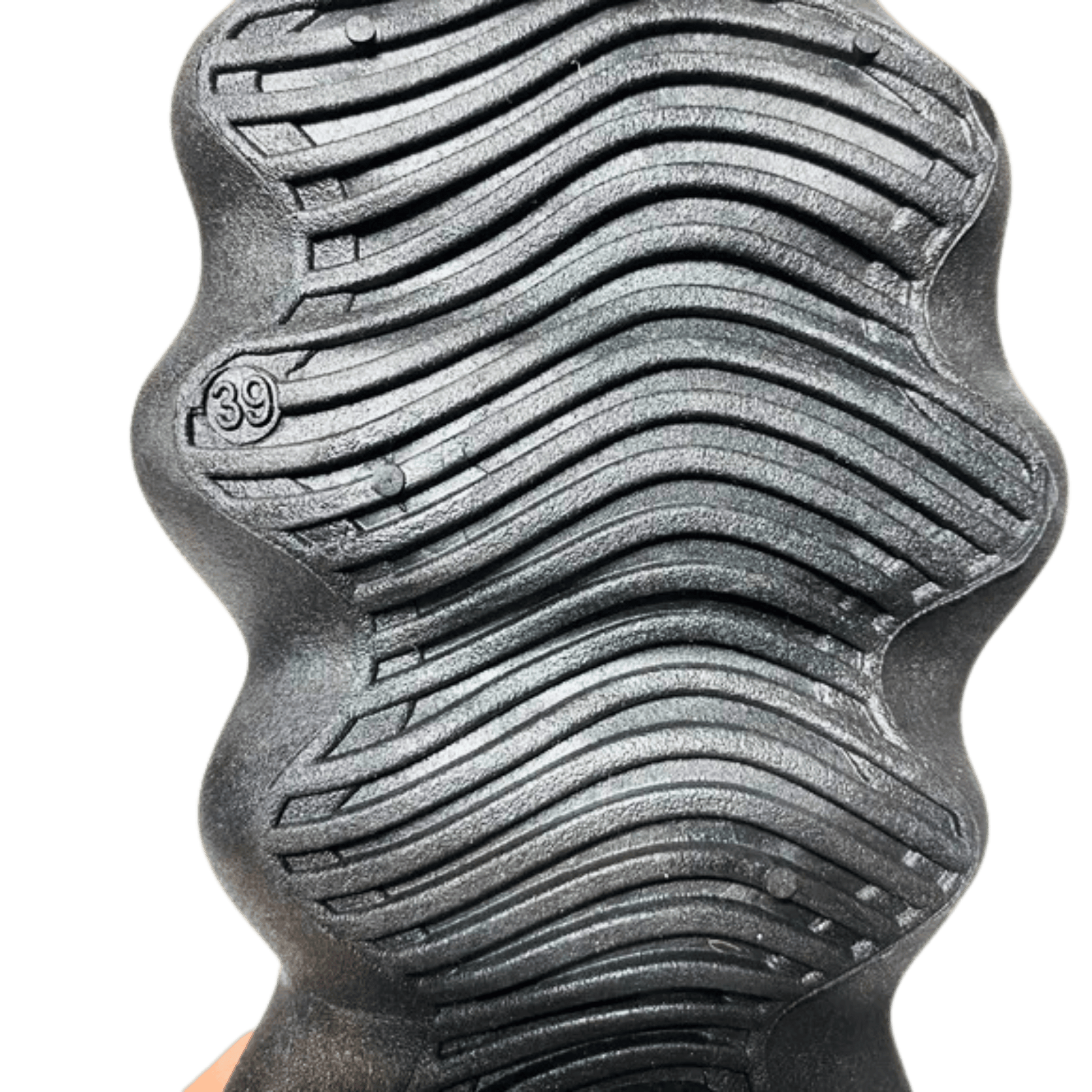 Close-up of a textured metal object with wavy pattern and '39' marking on a green background