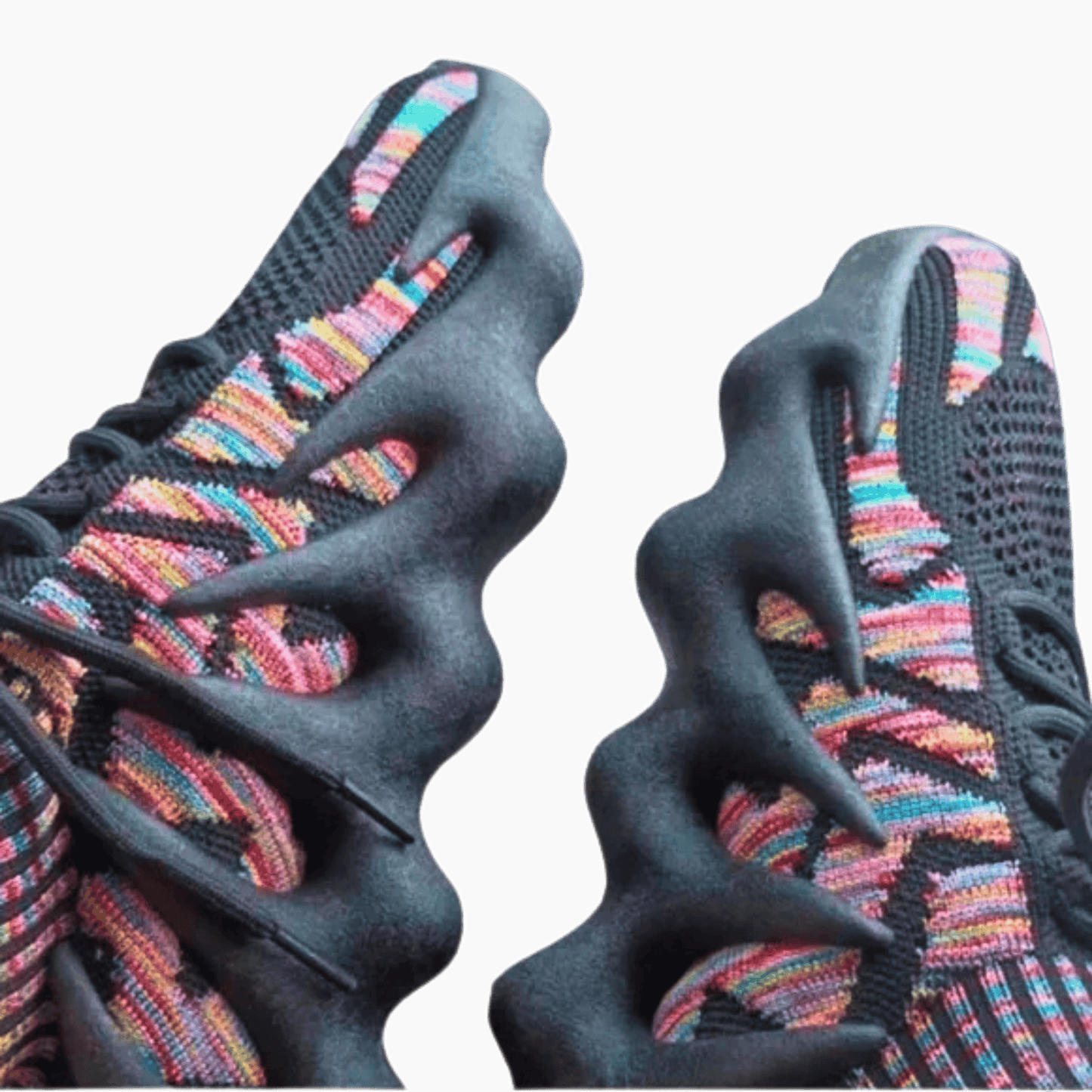 Close-up of black sneakers with colorful pattern on a gray background