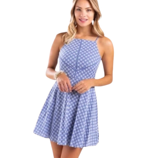 Woman wearing a blue polka dot dress on a white background