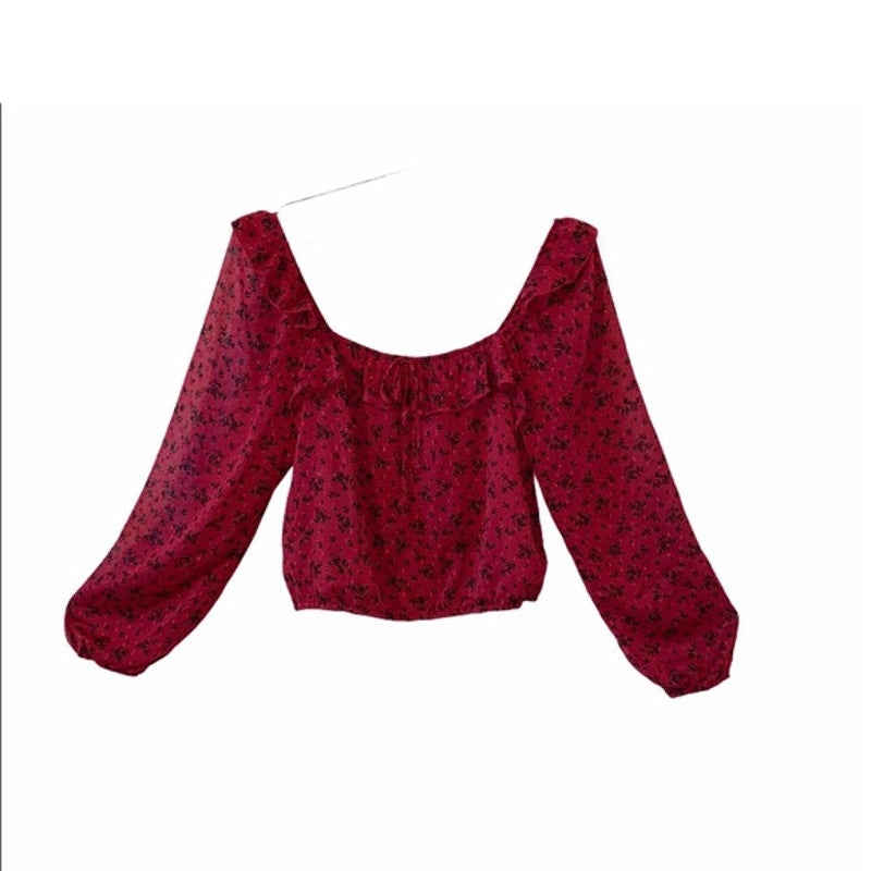 Red floral blouse with long sleeves on a white background