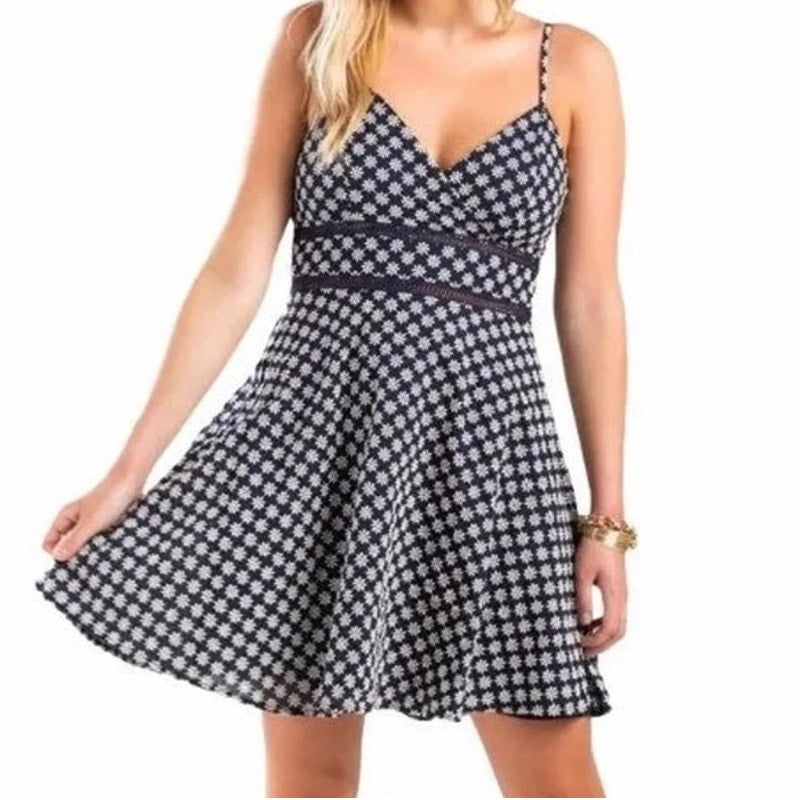 Black and white checkered dress worn by a model on a white background