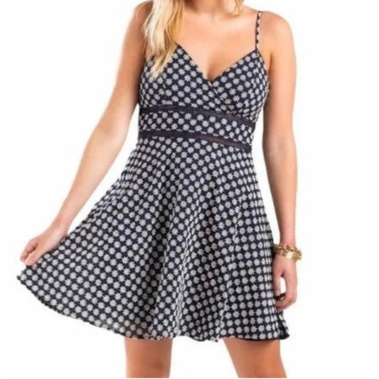 Black and white checkered dress worn by a model on a white background