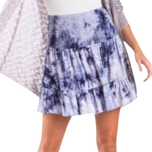 Tie-dye skirt worn by a person on a white background
