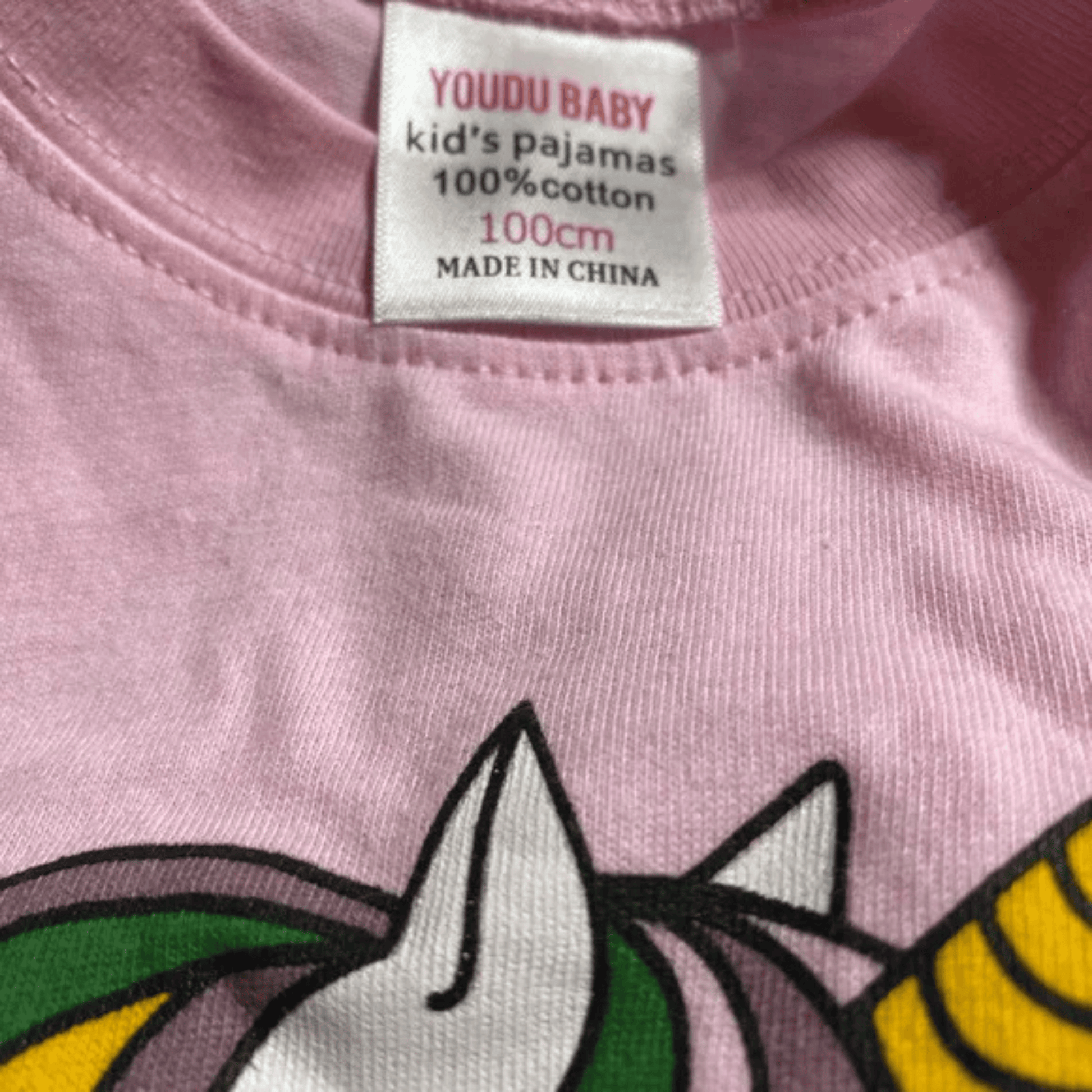 Pink pajama label with cartoon characters and 'YOU DU BABY' branding.