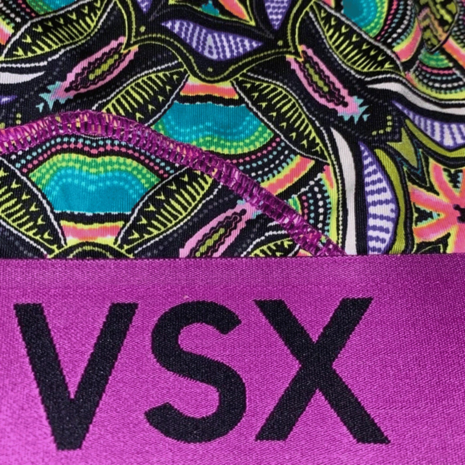 Colorful patterned fabric with 'VSX' logo on a purple background