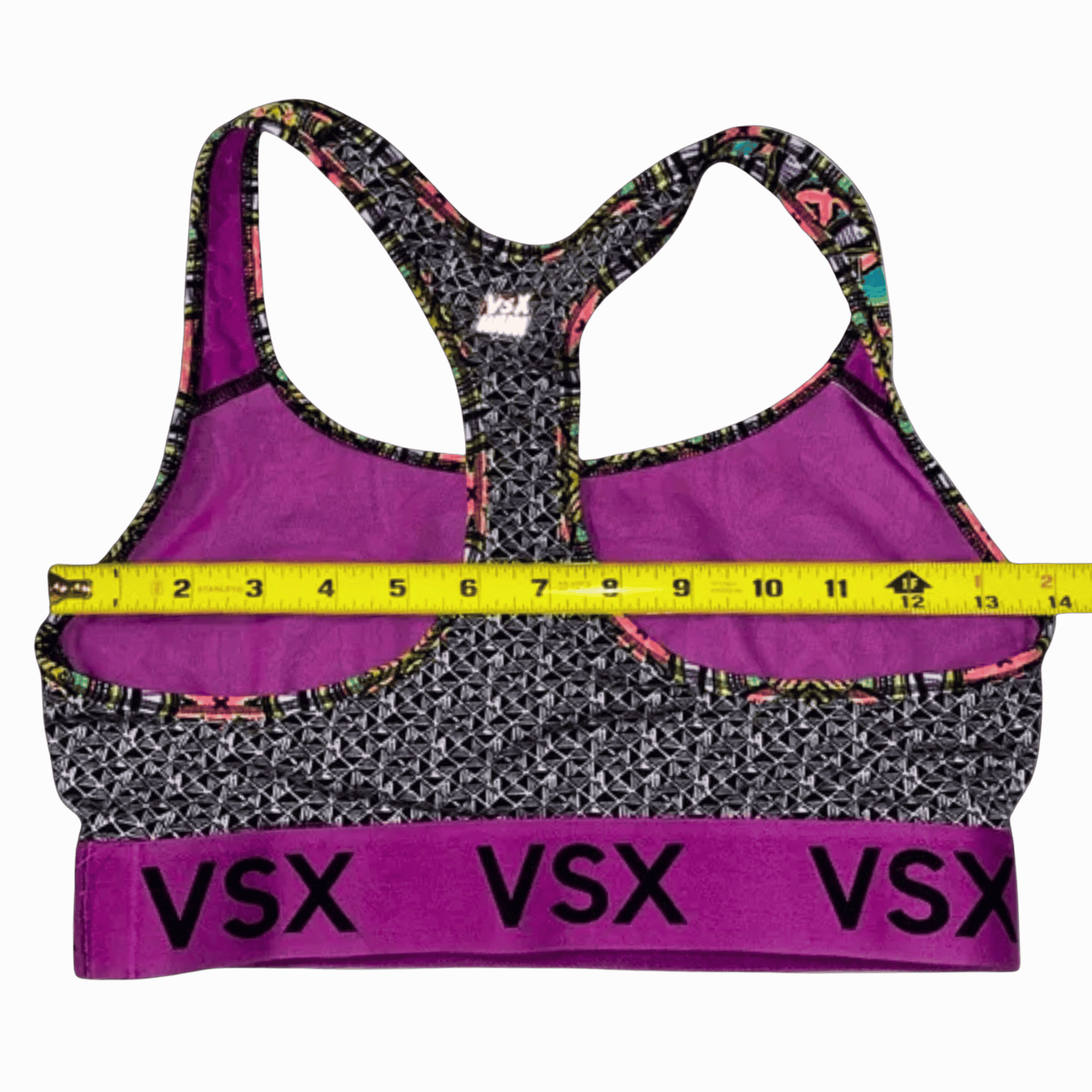 Multicolored sports bra with 'VSX' branding and a measuring tape on a gray background