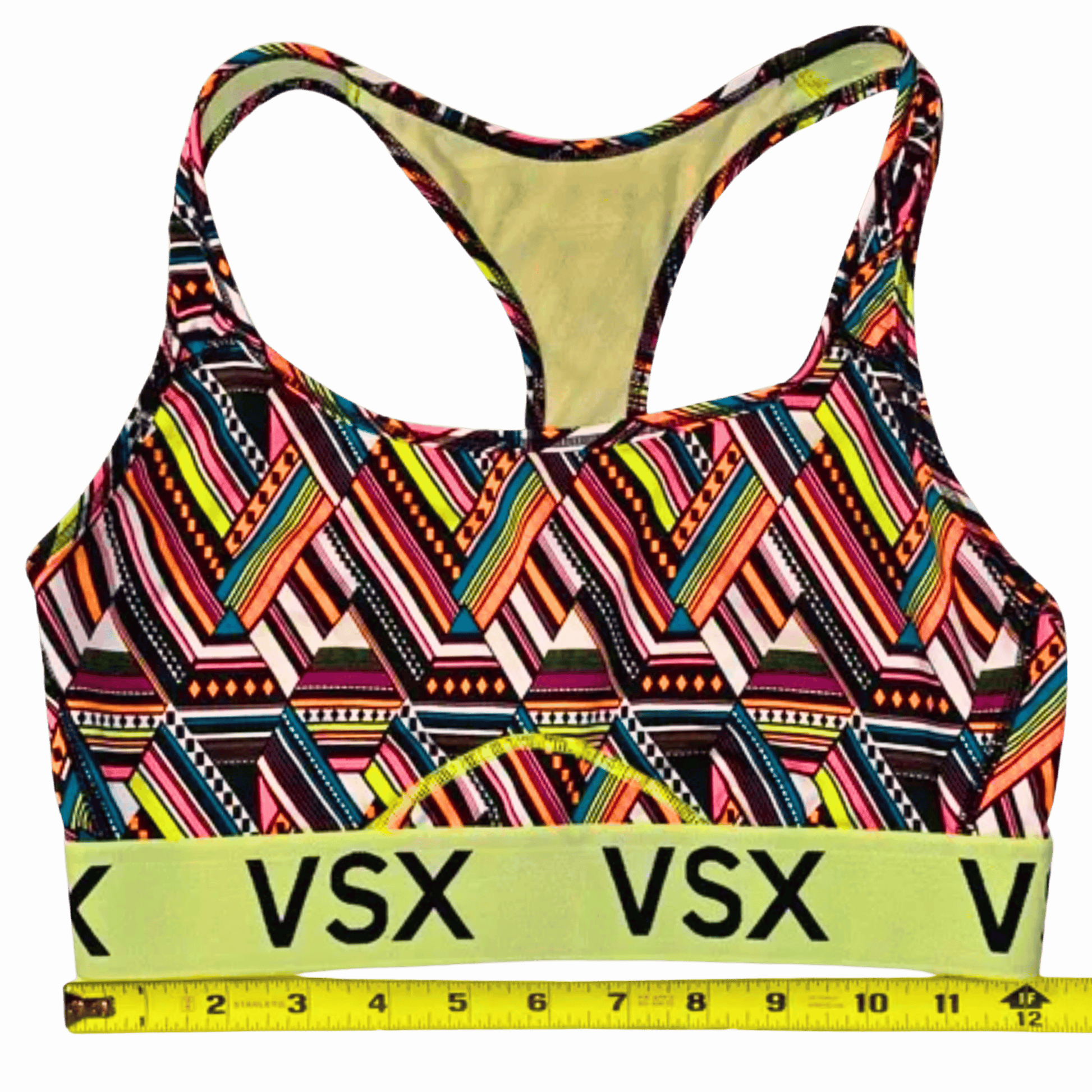 Colorful patterned sports bra with 'VSX' branding on a gray background