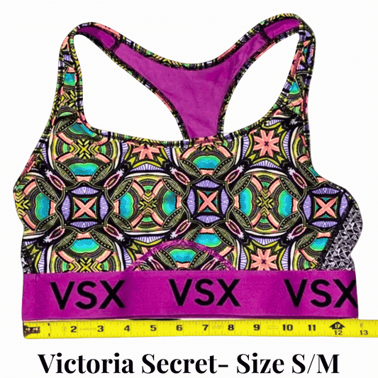 Victoria's Secret sports bra with colorful pattern and purple accents on a light green background
