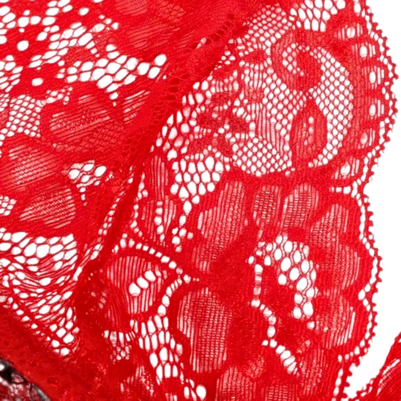 Close-up of red lace fabric with white floral patterns