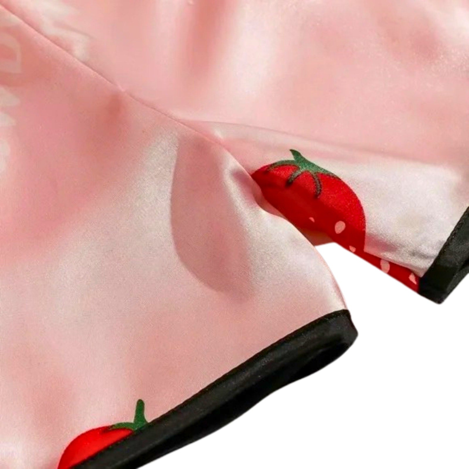 Pink shoe with red strawberry design on a white background