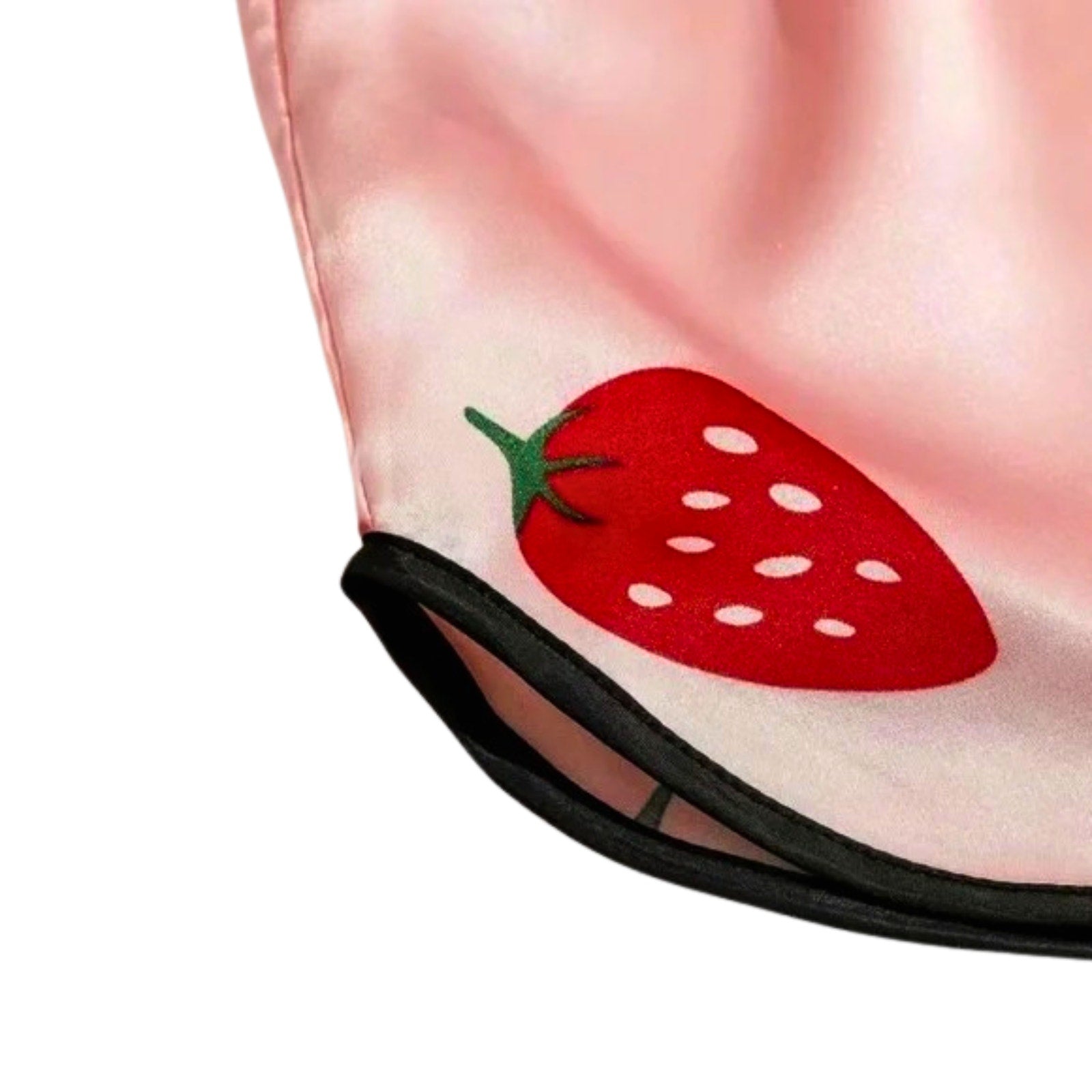 Close-up of a pink fabric with a red strawberry design on a white background