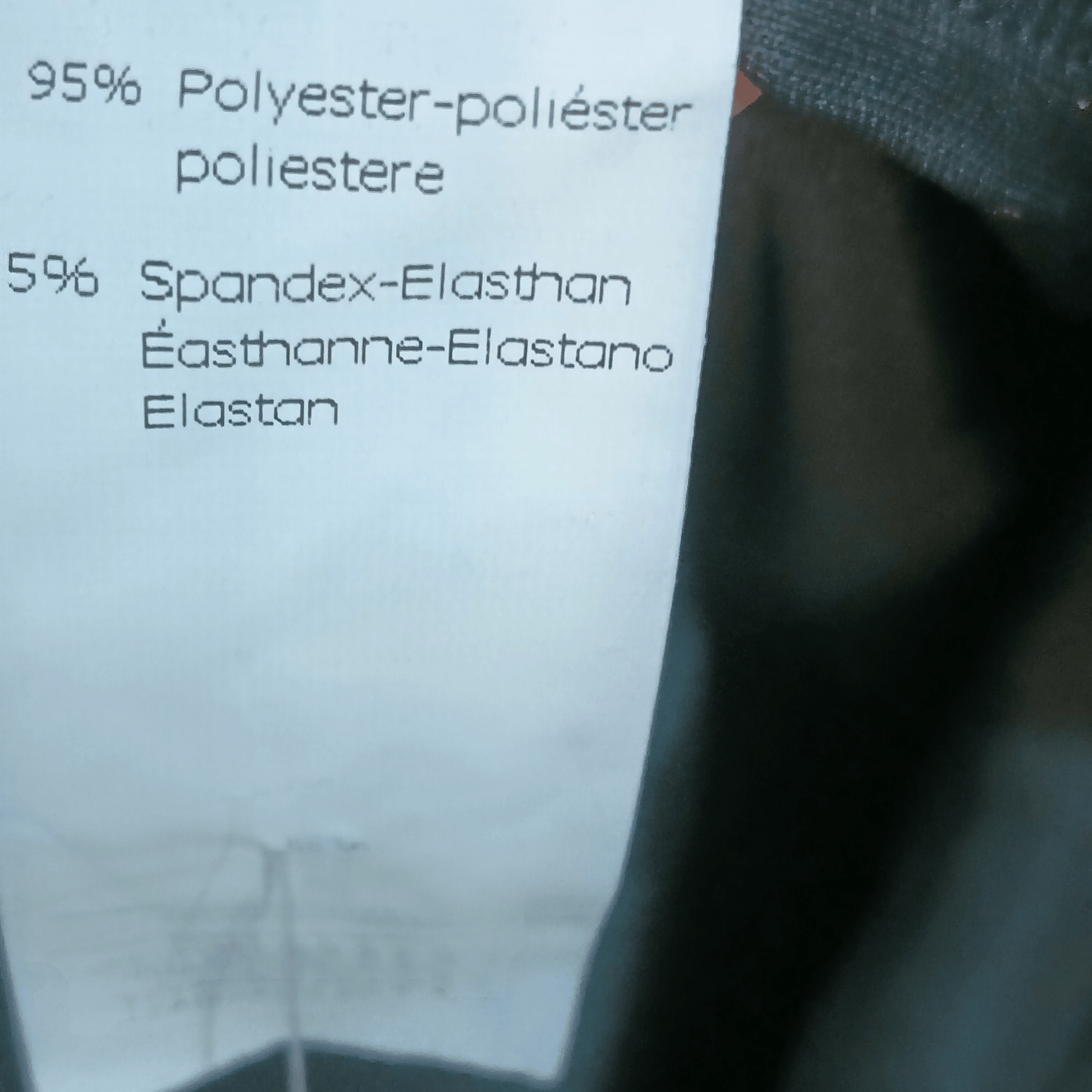 Text on a label detailing fabric composition with a blurred background