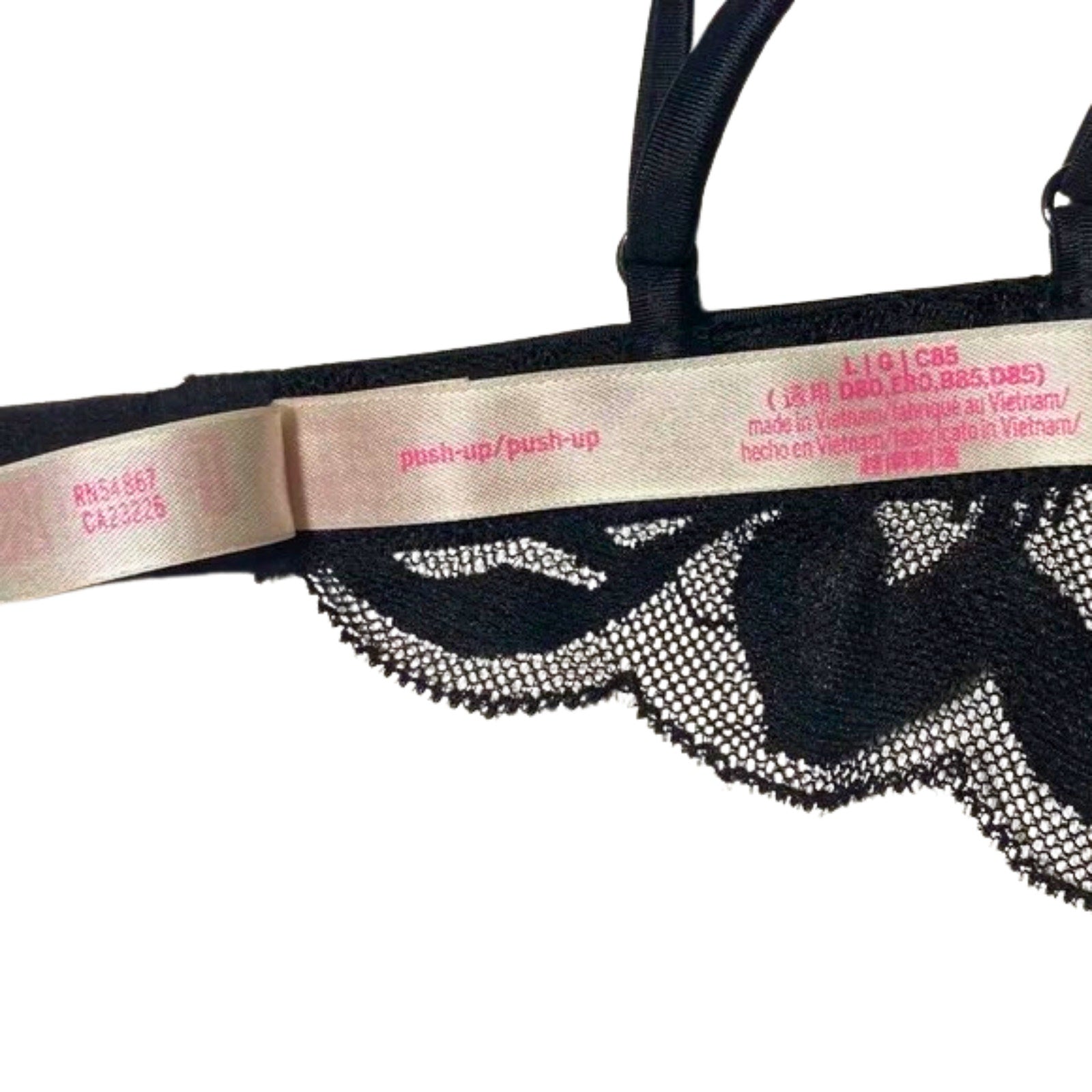 Black lace lingerie with a beige band displaying text on a white background