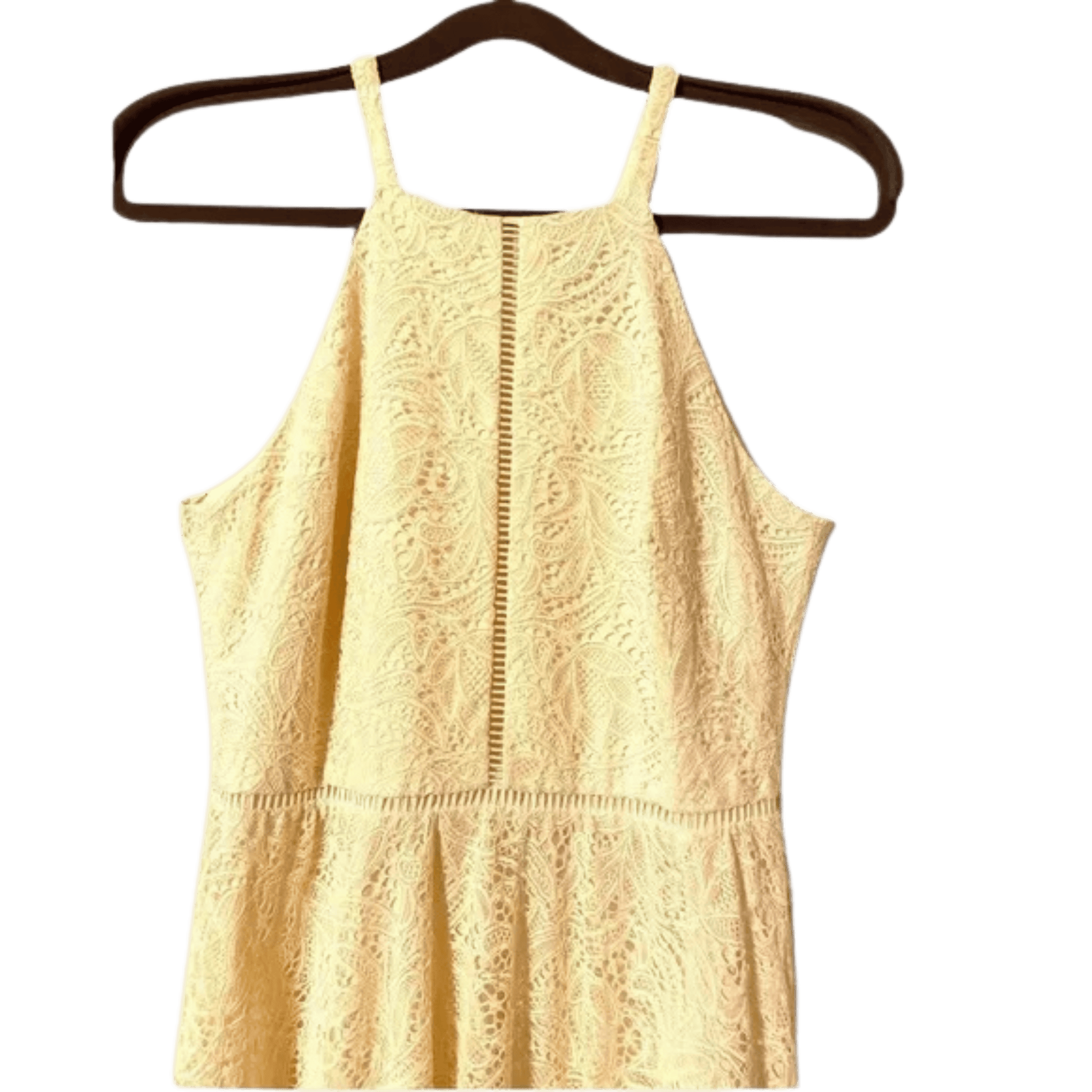 Yellow lace dress on a hanger against a white background