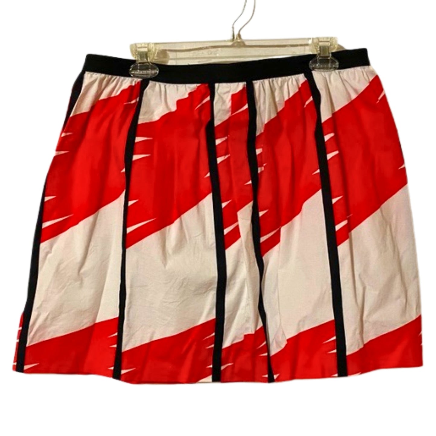 Red and white skirt with black accents on a hanger against a white background