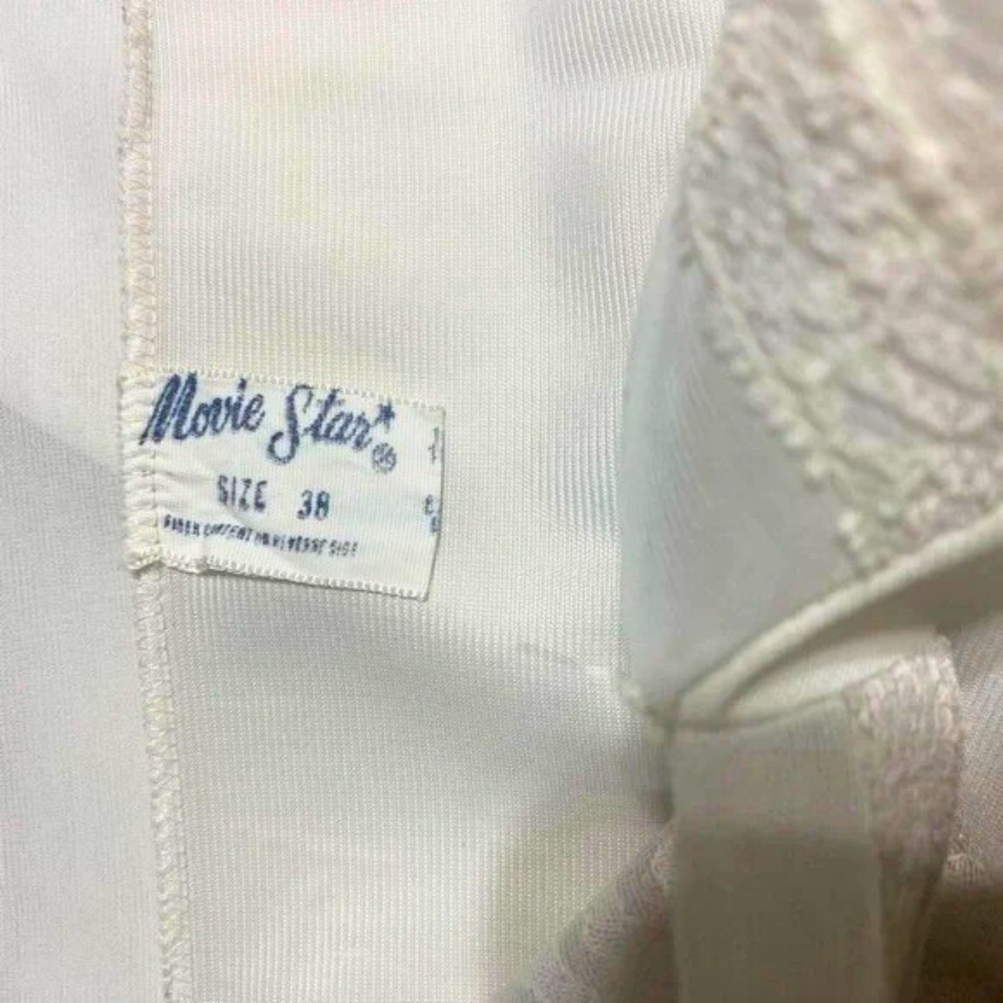 Close-up of a 'Movie Star' label on a garment with a blurred background.