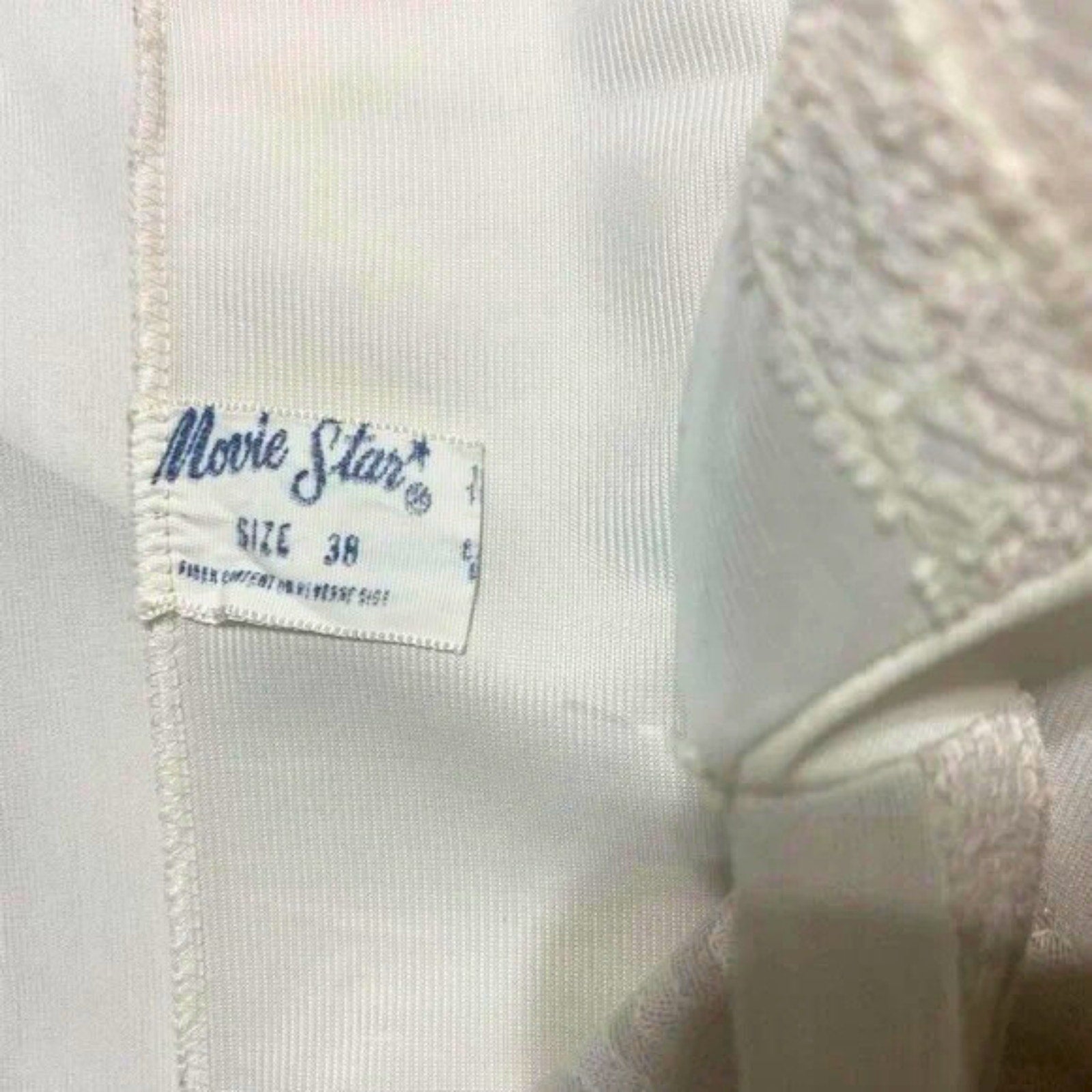 Close-up of a 'Movie Star' label on a garment with a blurred background.