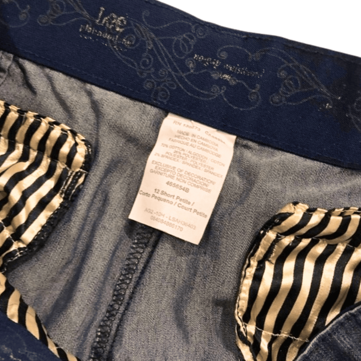 Close-up of a denim garment with a label and striped lining.