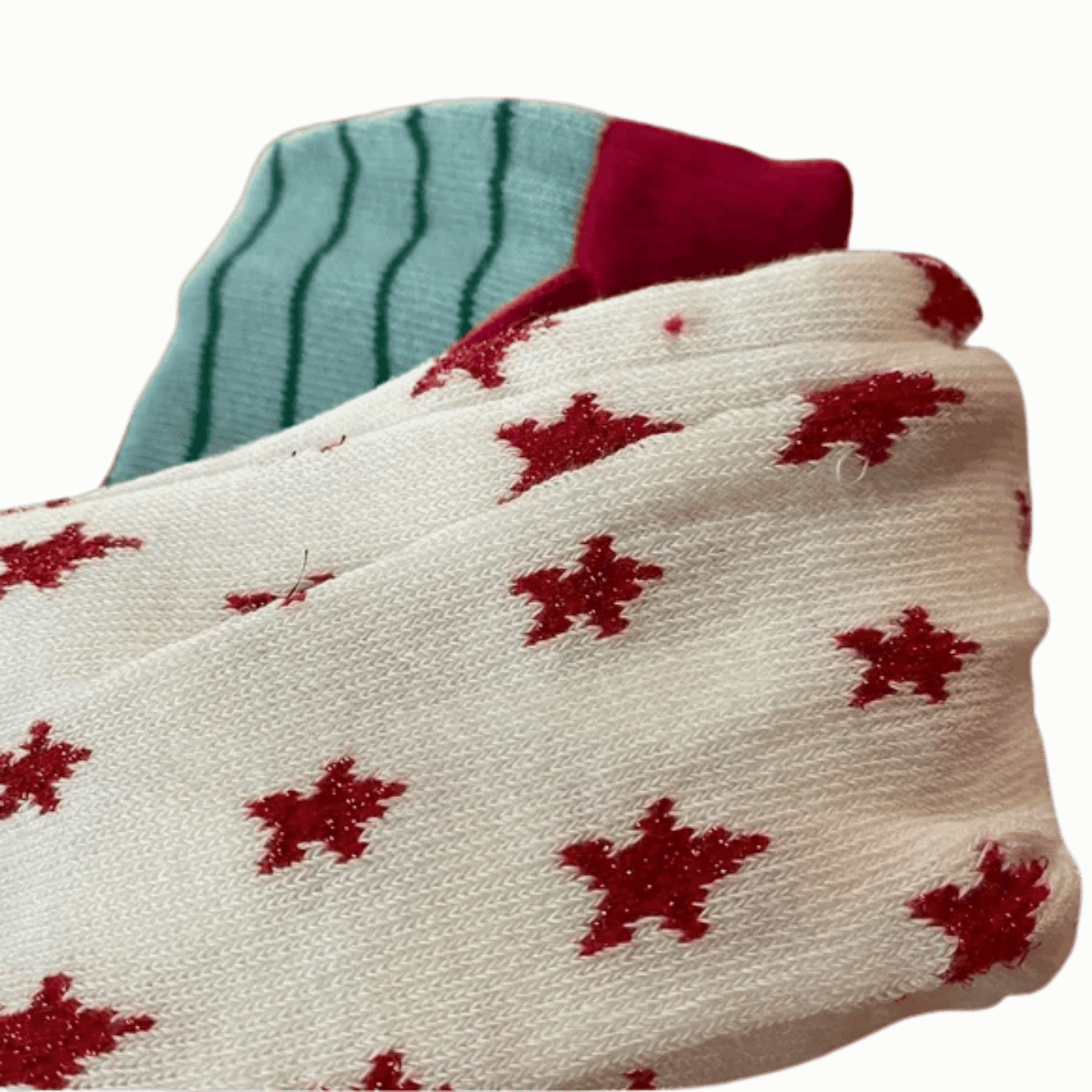Close-up of socks with red star patterns on a green background