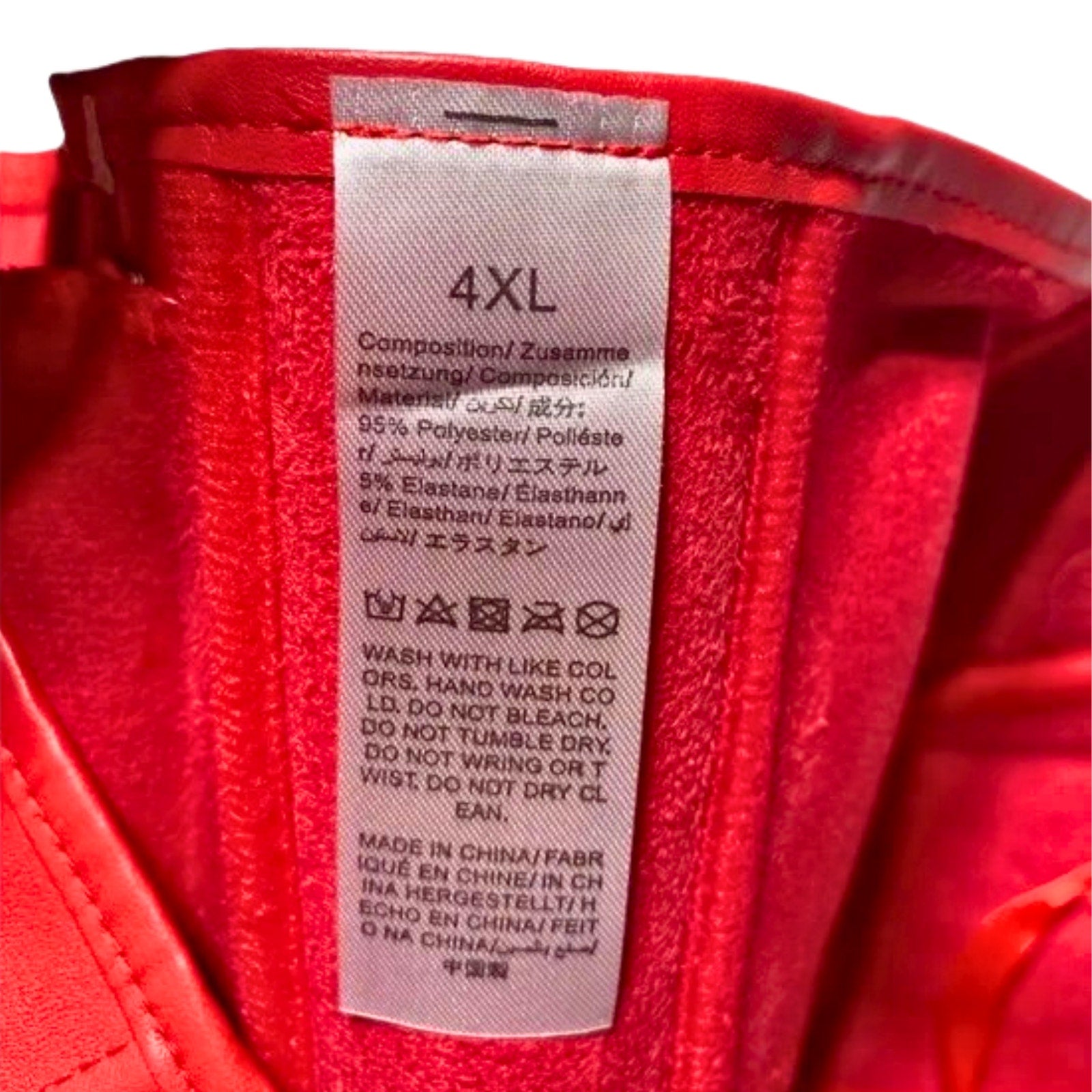 Red fabric with a label displaying size 4XL and care instructions.