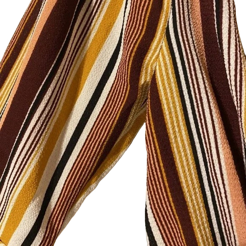 Close-up of striped fabric with brown, yellow, and black colors on a beige background