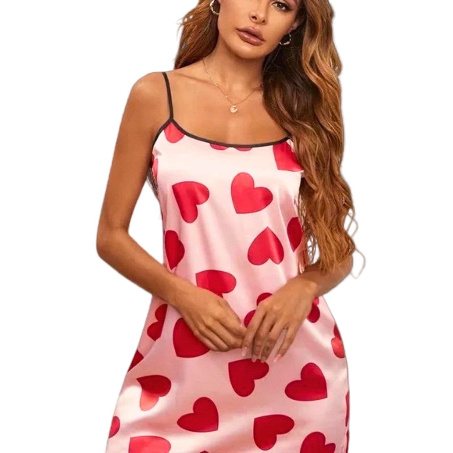 Woman wearing a pink slip dress with red heart patterns on a white background