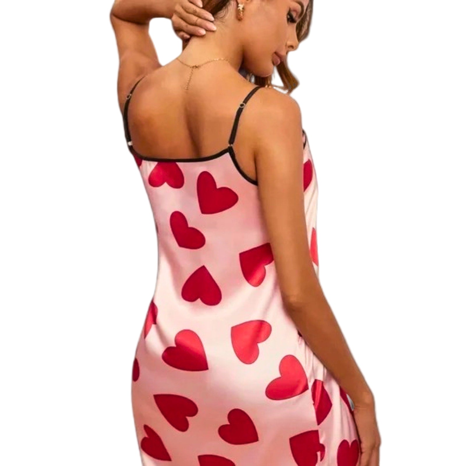 Woman wearing a pink slip dress with red heart patterns on a white background