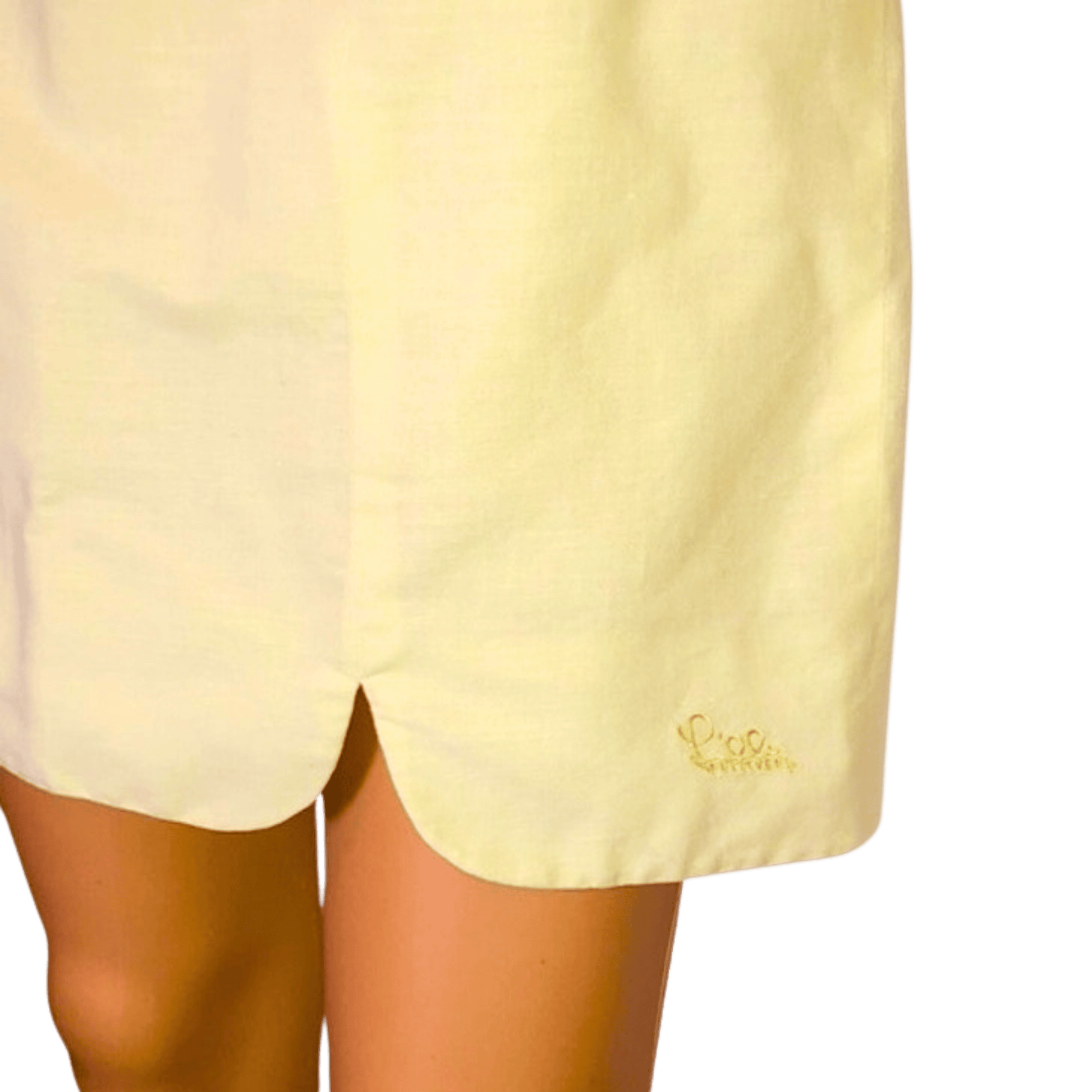 Light yellow shorts with a brand logo on a transparent background