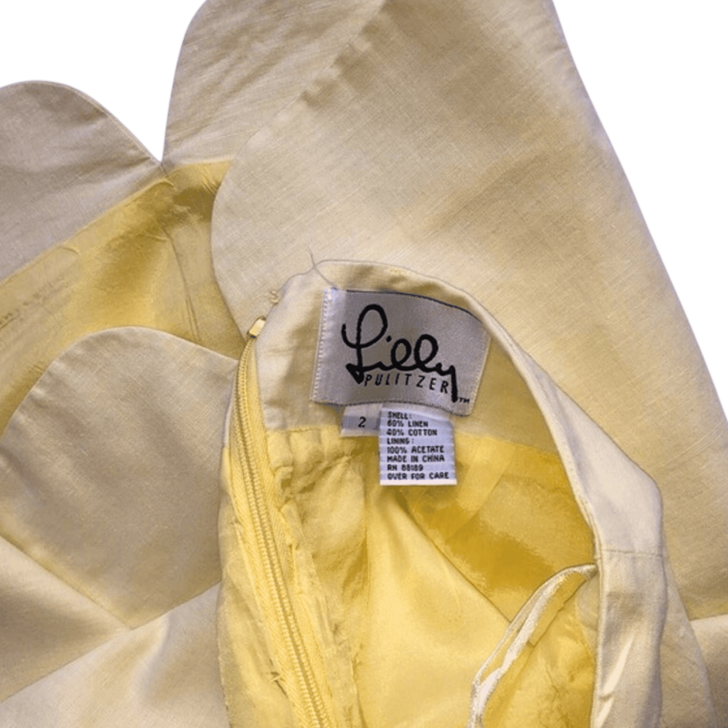 Close-up of a yellow jacket with a visible label on a green background