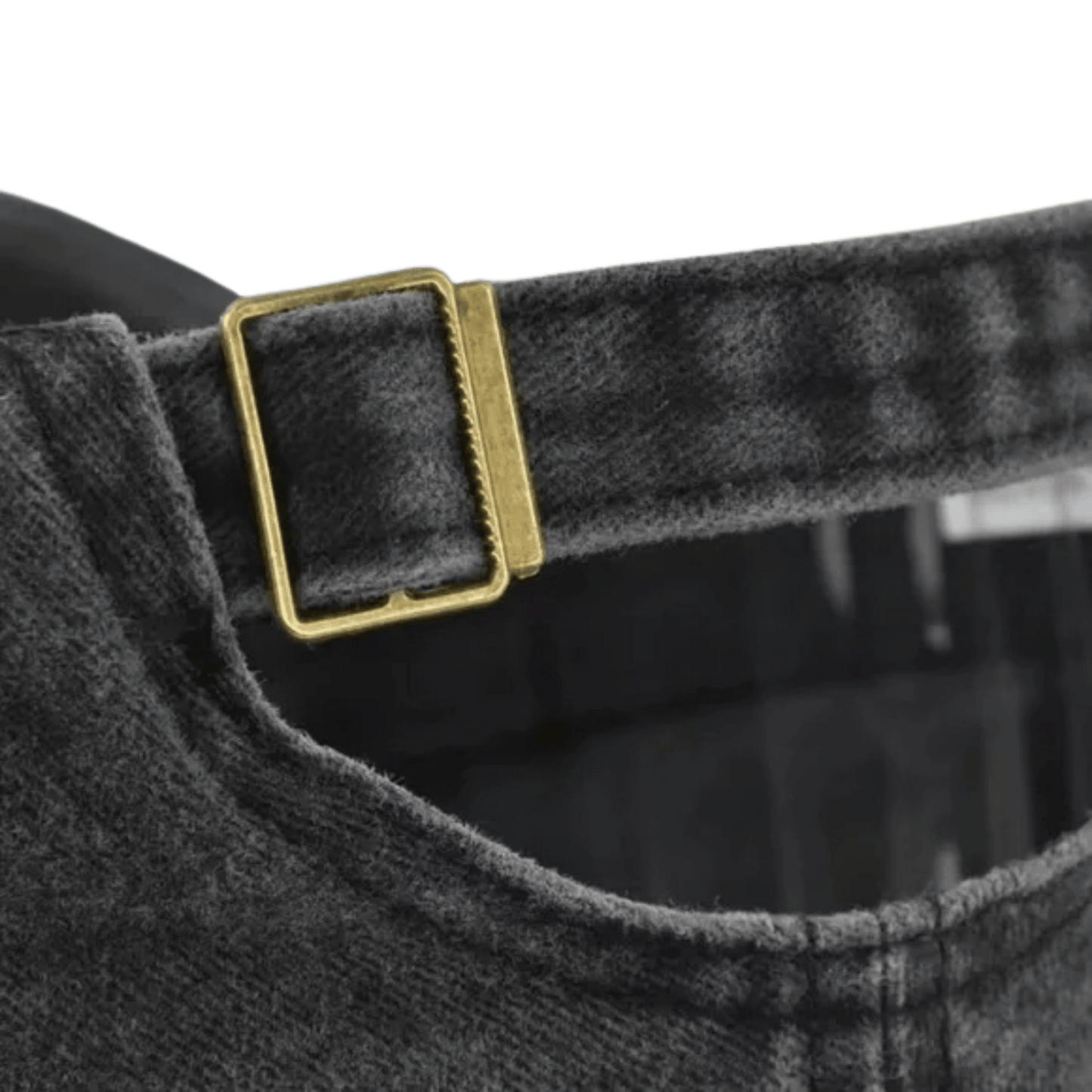 Close-up of a gray checkered shirt with a gold buckle on a green background