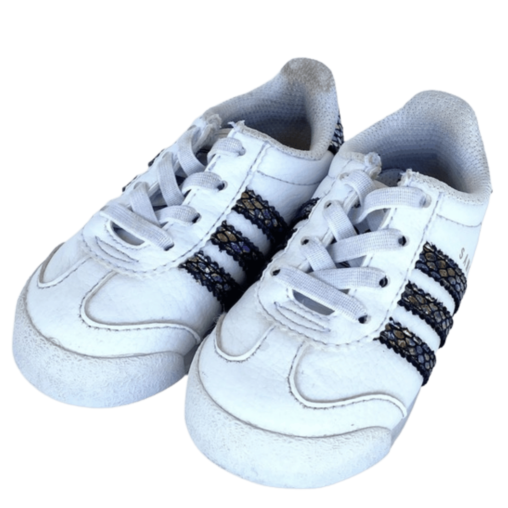 White sneakers with black and gold accents on a transparent background