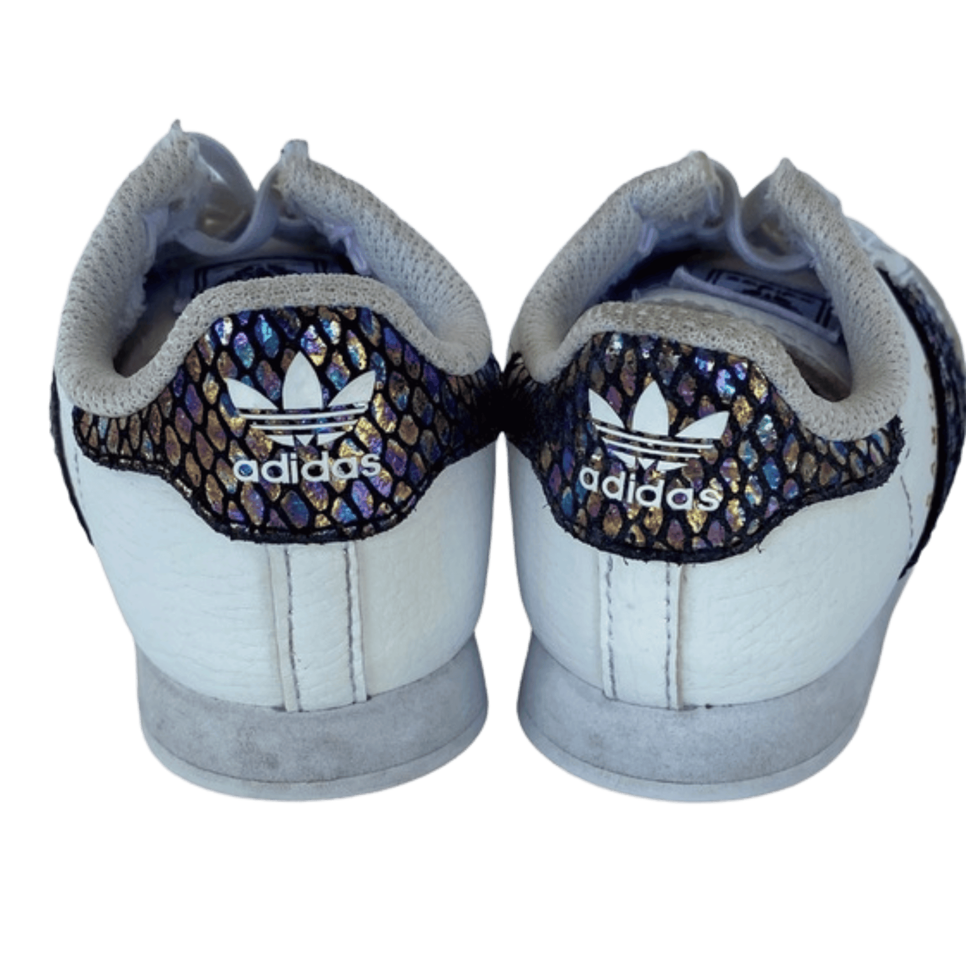 Pair of Adidas shoes with decorative heel tabs on a transparent background