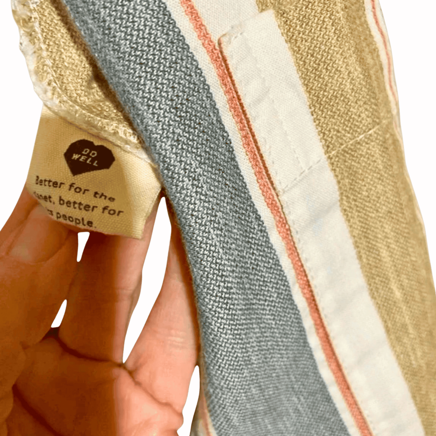 Striped fabric with a visible tag on a pink background