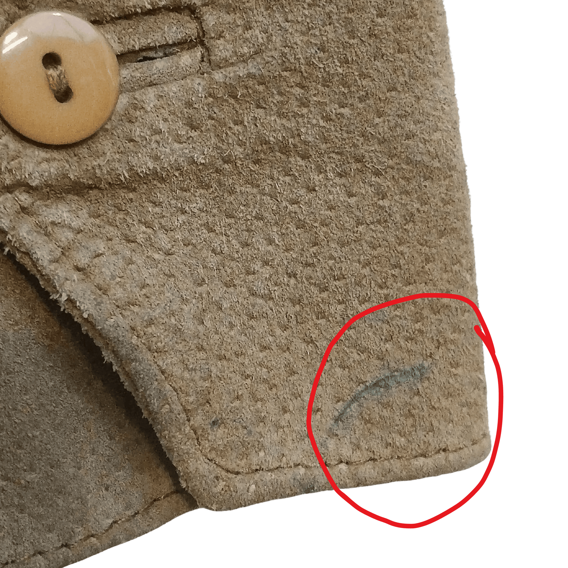 Close-up of a textured fabric surface with a button and a red circle highlighting an embroidered design.