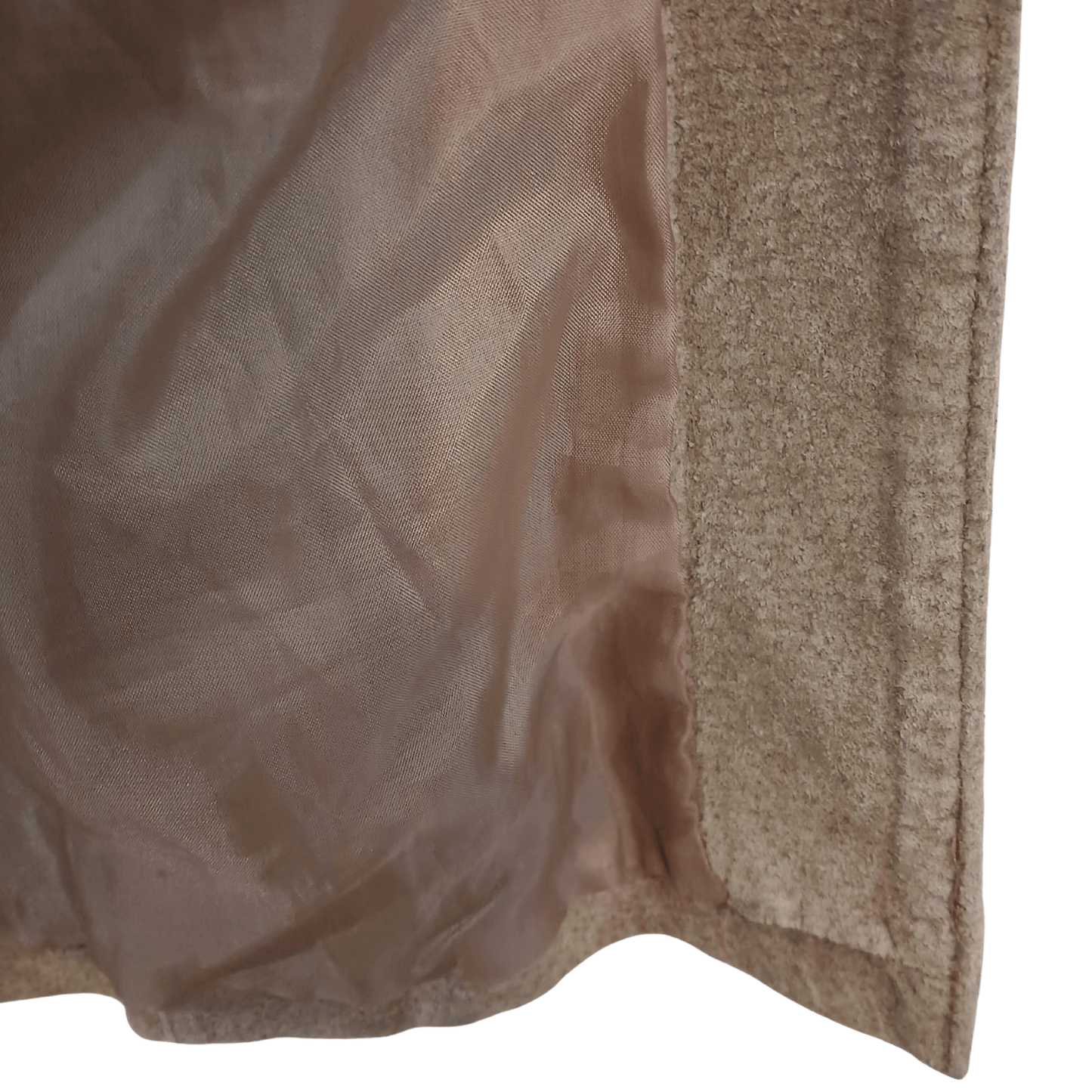 Close-up of a textured beige fabric with a green background