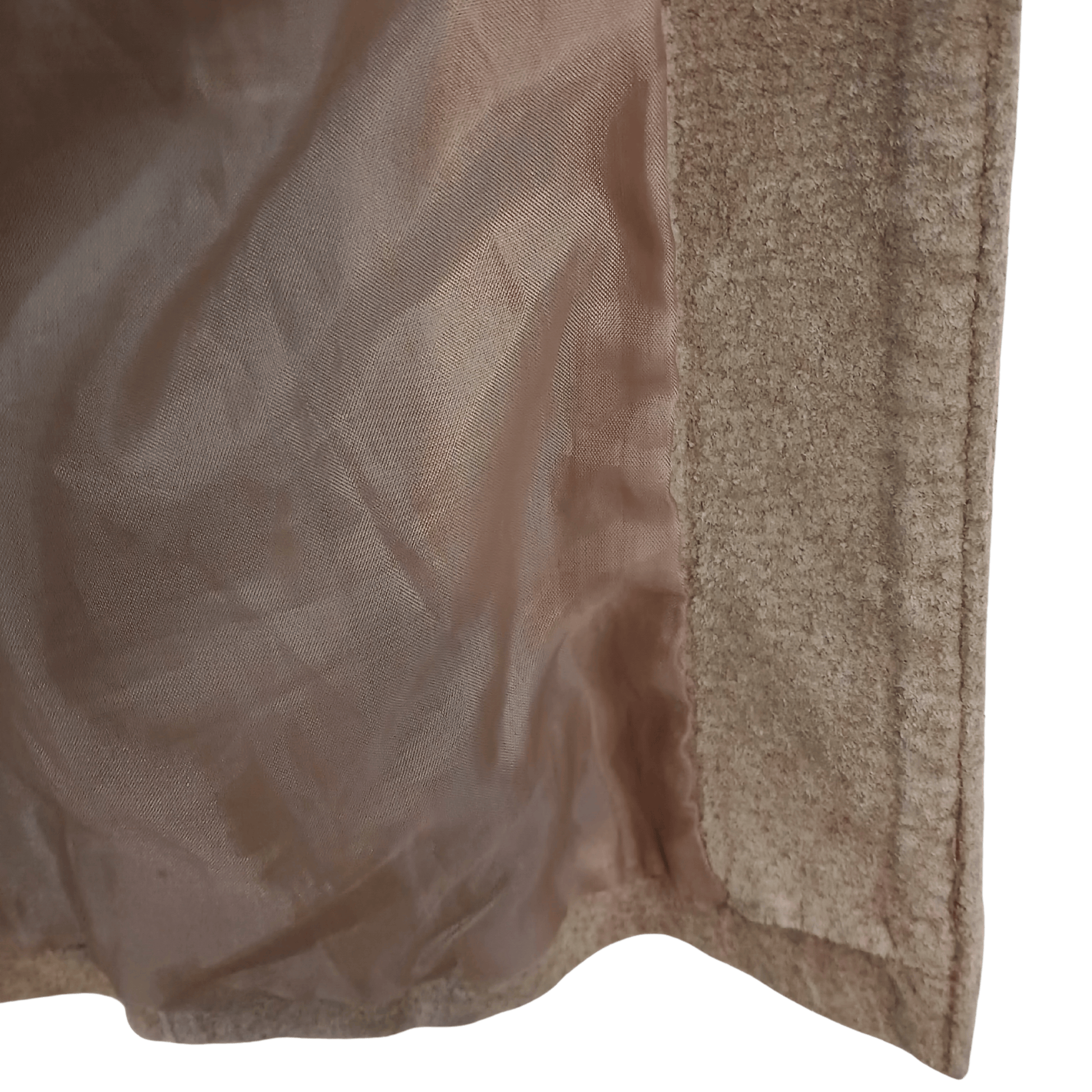 Close-up of a textured beige fabric with a green background