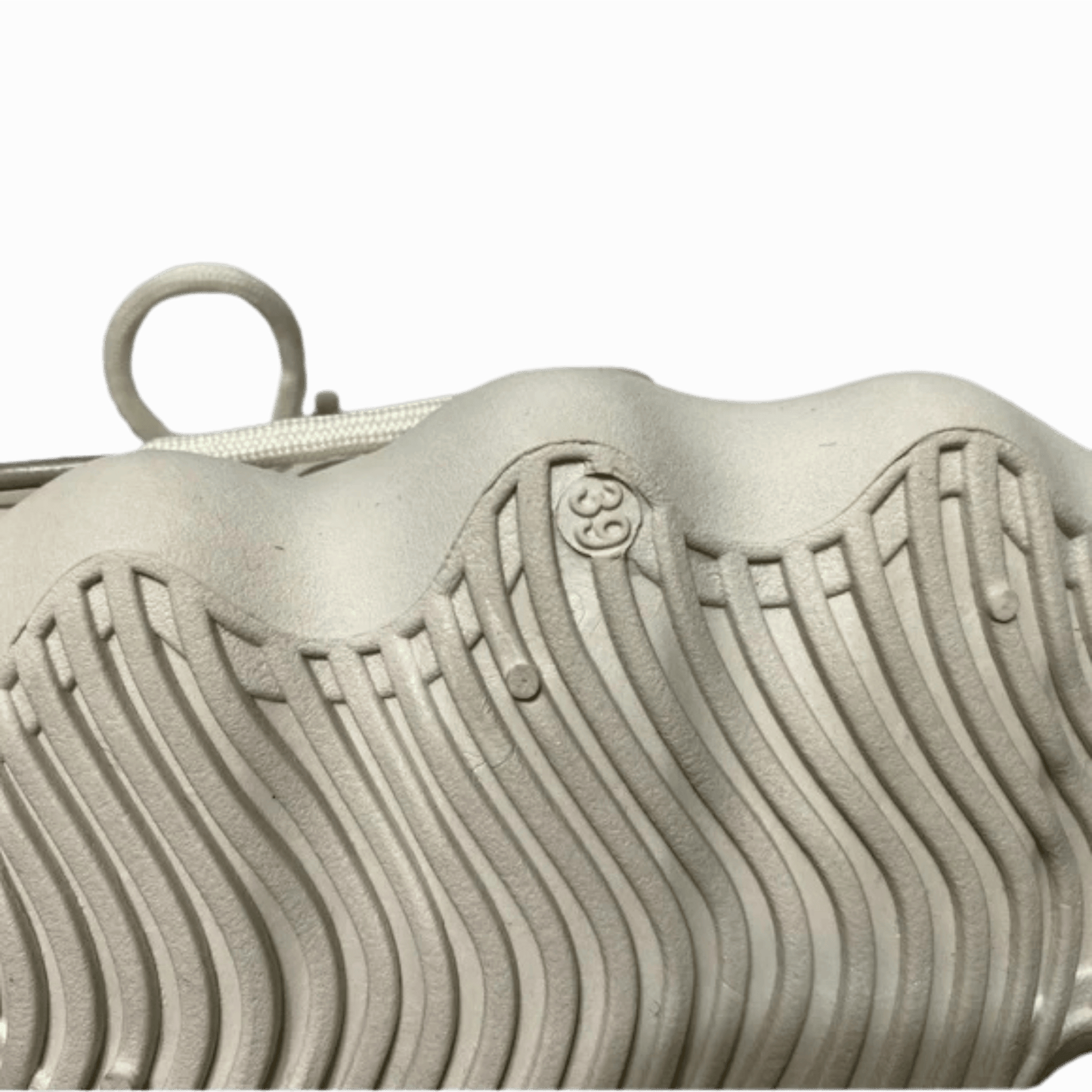 Close-up of a textured metallic object with a logo on a dark background