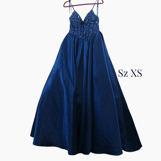 Blue evening gown with sequined top on a hanger against a dark background