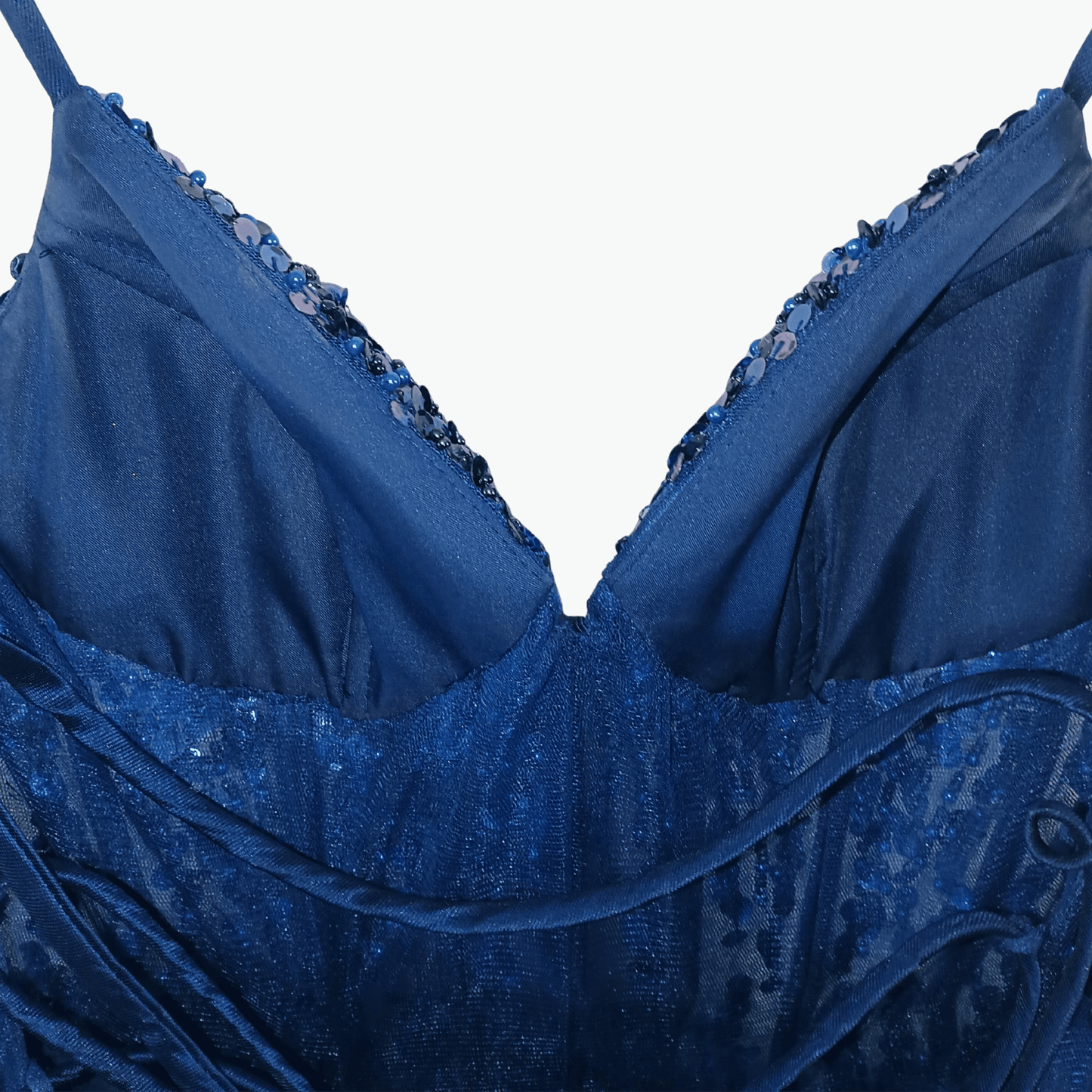Blue evening gown with intricate detailing on a gray background