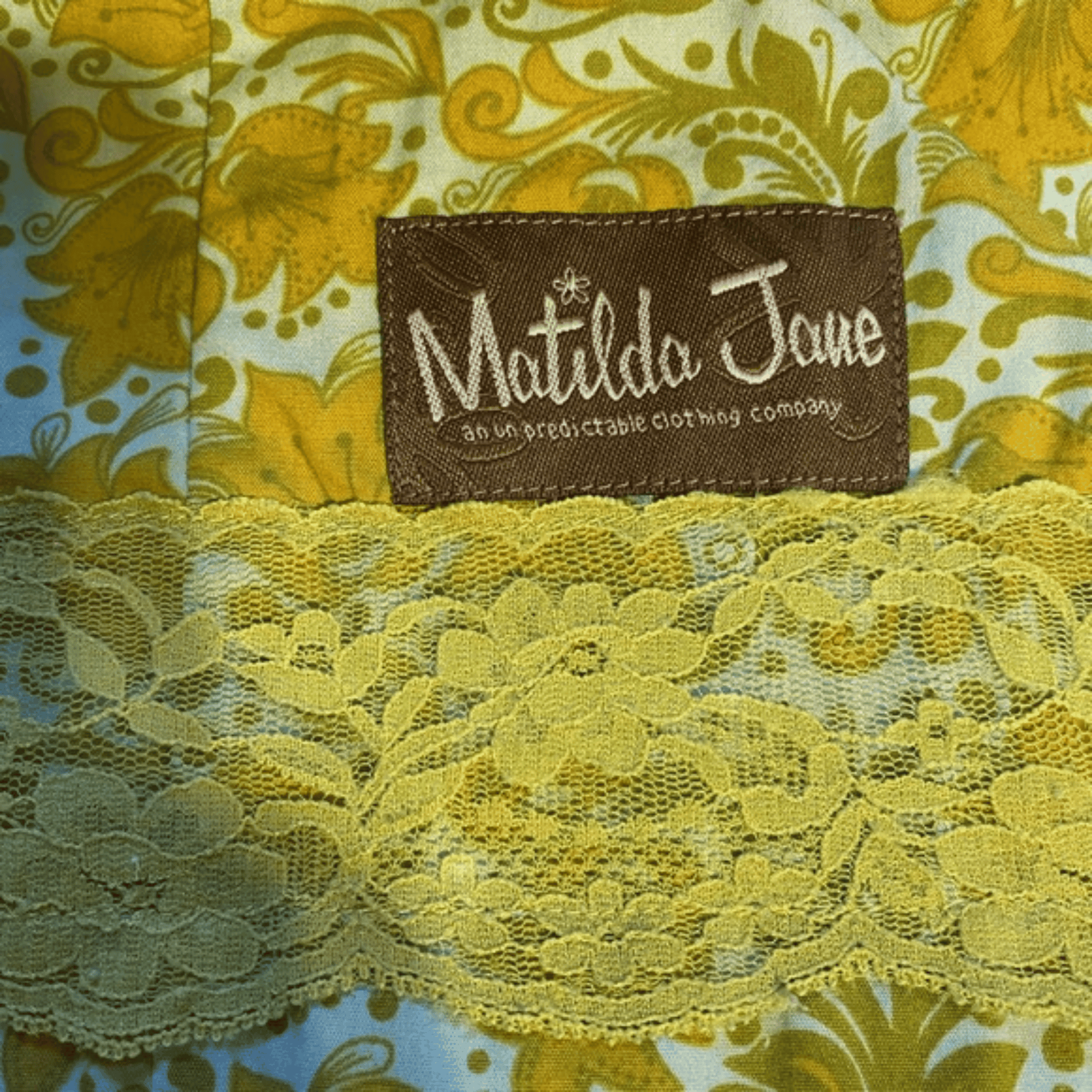 Close-up of a Matilda Jane label on a floral fabric background