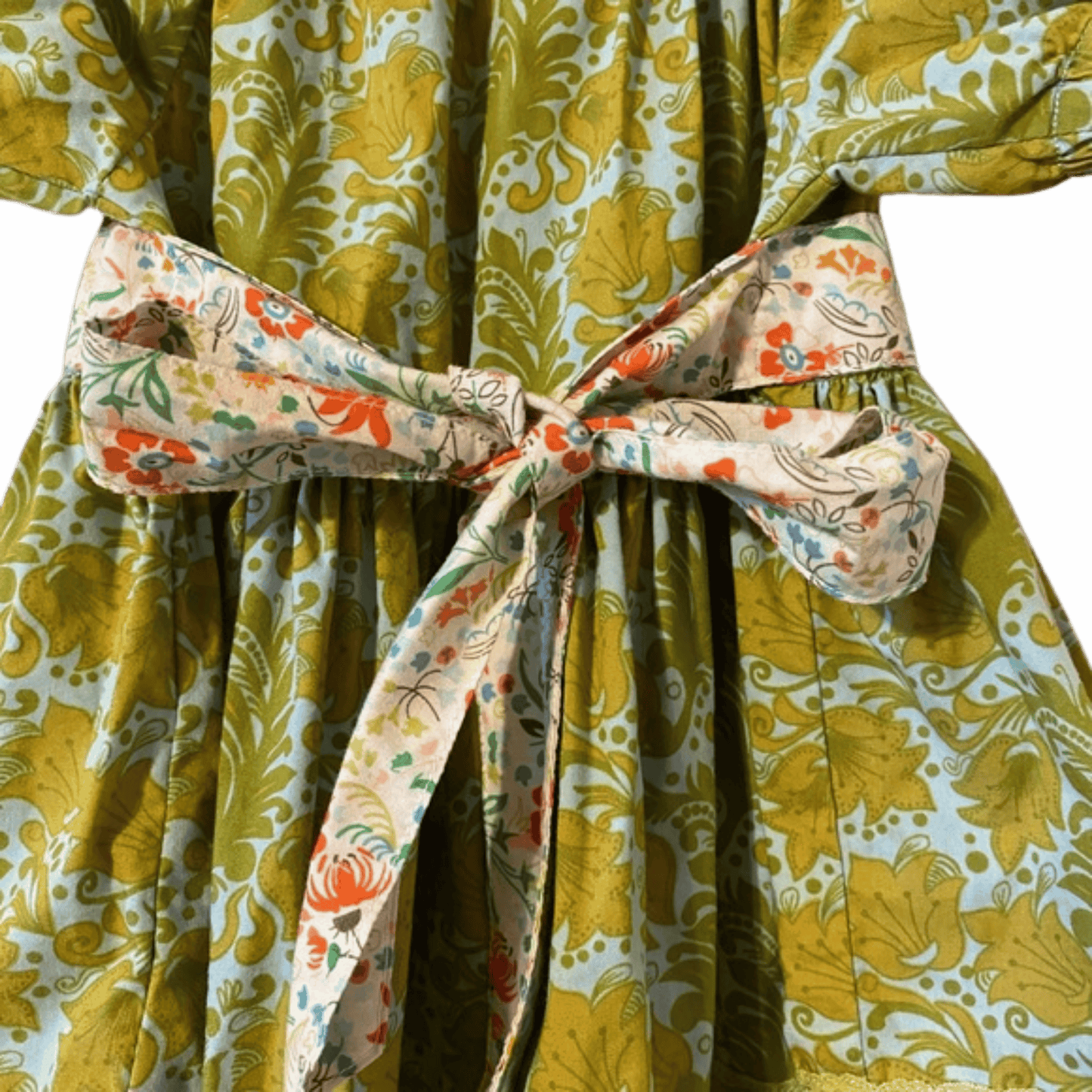 Floral-patterned robe with a colorful belt against a blue background