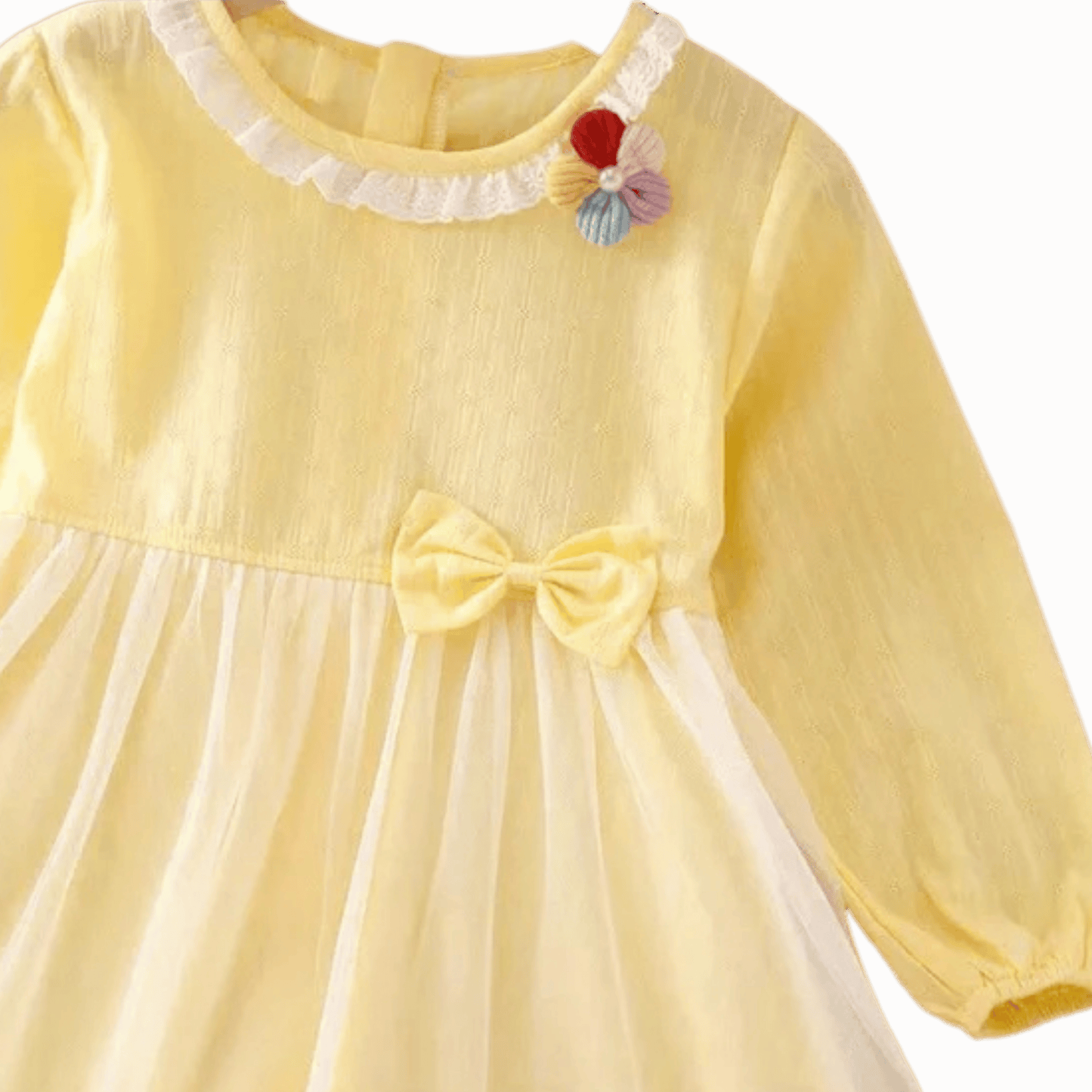 Yellow dress with a bow and colorful flowers on a brown background