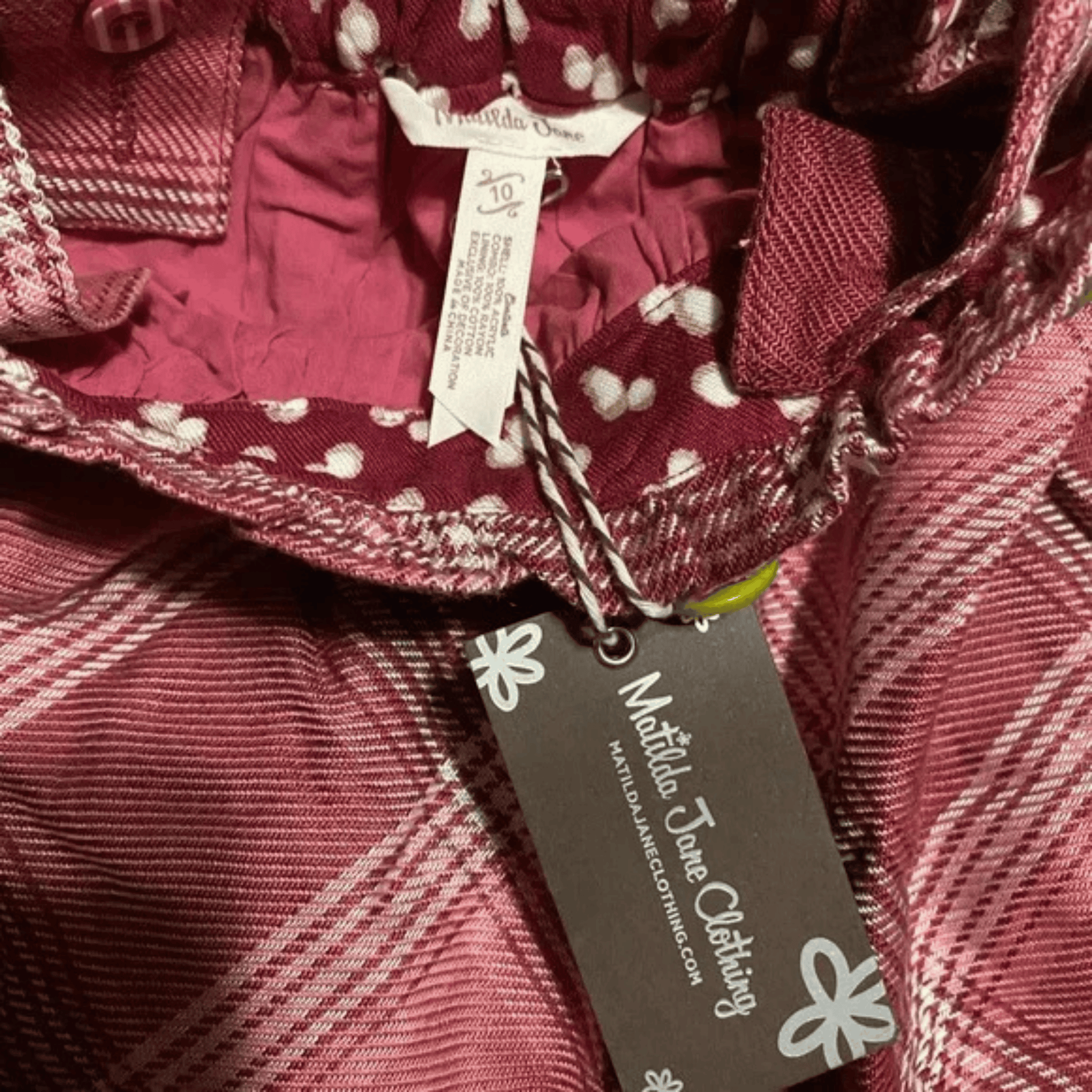 Maroon plaid fabric with a tag from Middleton Jane Clothing